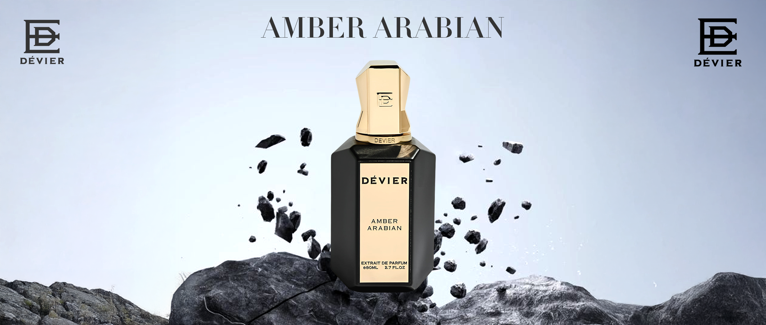 A sleek black and gold bottle of Dévier “Amber Arabian” stands boldly on rugged rock, evoking power, luxury, and timeless Arabian elegance.